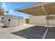 Covered parking area with street signage, a storage shed, and a clear view of the neighborhood at 1631 E Newport Dr, Tempe, AZ 85282