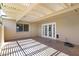 Large covered patio with lattice cover, stained concrete, with sliding windows and a door to the house at 1631 E Newport Dr, Tempe, AZ 85282