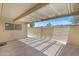 Spacious covered patio with patterned concrete and a lattice roof, with views of the lush greenery at 1631 E Newport Dr, Tempe, AZ 85282