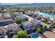 Scenic aerial view of neighborhood featuring lake, pools, and mountain views at 16425 S 34Th St, Phoenix, AZ 85048