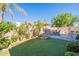 Backyard oasis with artificial turf, pool with waterfall and desert landscaping at 16425 S 34Th St, Phoenix, AZ 85048