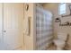 Bathroom featuring a toilet, shower with curtain, and a decorative shelf at 16425 S 34Th St, Phoenix, AZ 85048