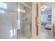 Ensuite bathroom featuring a glass shower, vanity and sink, with open doorway to the bedroom at 16425 S 34Th St, Phoenix, AZ 85048