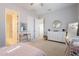 Bright bedroom with neutral tones, featuring a dresser, vanity, and open doorway to the bathroom at 16425 S 34Th St, Phoenix, AZ 85048