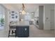 Open concept kitchen boasts stainless steel appliances, marble countertops and an island with barstool seating at 16425 S 34Th St, Phoenix, AZ 85048