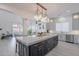 Gourmet kitchen boasts a large island with seating, designer lighting, and stainless steel appliances at 16425 S 34Th St, Phoenix, AZ 85048