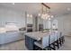 Modern kitchen boasts a large island with marble countertop, seating, and stylish lighting at 16425 S 34Th St, Phoenix, AZ 85048