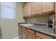 Convenient laundry room features a sink, cabinets, and plenty of counter space at 16425 S 34Th St, Phoenix, AZ 85048