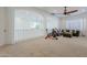 Spacious loft featuring white walls, a ceiling fan, an exercise bike, and comfortable seating at 16425 S 34Th St, Phoenix, AZ 85048