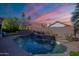 Backyard pool with stacked stone waterfall feature offers a serene outdoor retreat at 16425 S 34Th St, Phoenix, AZ 85048