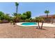 Private backyard with a pool, desert landscaping, and charming decor creates a tranquil outdoor space at 1643 N 144Th Dr, Goodyear, AZ 85395
