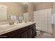 Well-lit bathroom features double sinks and shower-tub combo at 1643 N 144Th Dr, Goodyear, AZ 85395