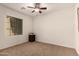 Neutral bedroom with a ceiling fan and beige carpeting perfect for relaxation at 1643 N 144Th Dr, Goodyear, AZ 85395