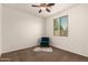 Inviting bedroom featuring a ceiling fan, window, and a teal chair at 1643 N 144Th Dr, Goodyear, AZ 85395