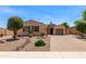 Charming single-story home with desert landscaping, brick driveway, and barrel roof accents at 1643 N 144Th Dr, Goodyear, AZ 85395