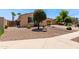 Charming home featuring desert landscaping with natural stone and a brick paved driveway at 1643 N 144Th Dr, Goodyear, AZ 85395