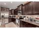 Close-up of the kitchen area, featuring stainless steel appliances and granite countertops at 1643 N 144Th Dr, Goodyear, AZ 85395