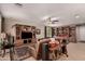 Open living area with custom built-in shelving, ceiling fan, leather sofa and travertine floors at 1643 N 144Th Dr, Goodyear, AZ 85395