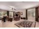 Bright, airy living room featuring large windows, tile flooring, and a ceiling fan at 1643 N 144Th Dr, Goodyear, AZ 85395