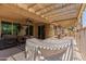 Covered patio has view of outdoor kitchen, seating area and pool at 1643 N 144Th Dr, Goodyear, AZ 85395