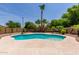 Beautiful private pool surrounded by palm trees and lush landscaping, perfect for relaxation and enjoyment at 1643 N 144Th Dr, Goodyear, AZ 85395