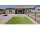 Backyard with a paver patio, turf area, black metal fence enclosing a pool, and privacy walls at 16836 W Vereda Solana Dr, Surprise, AZ 85387