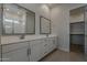 Modern bathroom features double sinks, white cabinets, and tile flooring at 16836 W Vereda Solana Dr, Surprise, AZ 85387
