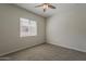 Neutral bedroom with carpeted floors, a ceiling fan, and a window with horizontal blinds at 16836 W Vereda Solana Dr, Surprise, AZ 85387