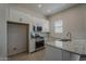 Modern kitchen boasts stainless steel appliances, granite countertops, and ample cabinet space at 16836 W Vereda Solana Dr, Surprise, AZ 85387