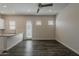 Open-concept living room features hard wood flooring, a ceiling fan and neutral tones at 16836 W Vereda Solana Dr, Surprise, AZ 85387