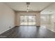 Bright living space with sliding glass door access to outdoor patio and modern ceiling fan at 16836 W Vereda Solana Dr, Surprise, AZ 85387