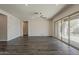 Expansive living room with dark flooring and a sliding glass door to the backyard at 16836 W Vereda Solana Dr, Surprise, AZ 85387