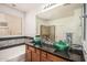 Modern bathroom with dual green vessel sinks, granite countertop, tile backsplash, and a glass-enclosed shower at 1721 W Kingbird Dr, Chandler, AZ 85286