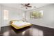 Sunlit bedroom features hardwood floors, white walls, and a large window highlighting a yellow platform bed with matching nightstand at 1721 W Kingbird Dr, Chandler, AZ 85286