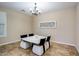 Cozy dining room features modern chandelier and unique table with stylish cushioned chairs at 1721 W Kingbird Dr, Chandler, AZ 85286
