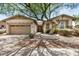 Charming single-story home featuring a large tree in the front yard at 1721 W Kingbird Dr, Chandler, AZ 85286