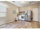 Large laundry room equipped with washer, dryer, shelving, refrigerator, and large window at 1721 W Kingbird Dr, Chandler, AZ 85286