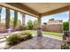 Inviting covered patio with tile flooring, manicured landscaping, and outdoor seating area, perfect for relaxing and entertaining at 1721 W Kingbird Dr, Chandler, AZ 85286