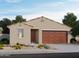Charming single-story home with neutral colors, a two-car garage, and low-maintenance desert landscaping at 17334 W Eva St, Waddell, AZ 85355