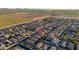 An aerial view showcasing the house in a neighborhood with farmland in the distance at 18344 W Getty Dr, Goodyear, AZ 85338