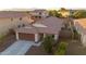 Aerial view of a well-kept house in a residential area with a two-car garage and tiled roof at 18344 W Getty Dr, Goodyear, AZ 85338