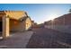 View of a spacious backyard with low-maintenance landscaping and a privacy wall at 18344 W Getty Dr, Goodyear, AZ 85338