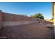 Large backyard offering a simple design with stone and block wall fencing at 18344 W Getty Dr, Goodyear, AZ 85338