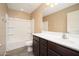Bathroom featuring a sink and vanity, large mirror, tub and shower combination at 18344 W Getty Dr, Goodyear, AZ 85338
