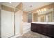 Bathroom featuring double sinks, bathtub, walk in shower, and tile flooring at 18344 W Getty Dr, Goodyear, AZ 85338