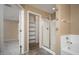 Bathroom featuring walk-in shower, bathtub, and shelves at 18344 W Getty Dr, Goodyear, AZ 85338