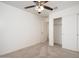 Bedroom with neutral carpet, white walls, ceiling fan, closet and entrance doorway at 18344 W Getty Dr, Goodyear, AZ 85338