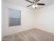 Bedroom with neutral carpet, white walls, ceiling fan, and a window with blinds at 18344 W Getty Dr, Goodyear, AZ 85338