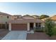 Lovely single-story home with a two-car garage, welcoming porch, and well-maintained front yard at 18344 W Getty Dr, Goodyear, AZ 85338