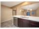 Bright kitchen featuring stainless steel appliances, dark wood cabinets, and white countertop with breakfast bar at 18344 W Getty Dr, Goodyear, AZ 85338